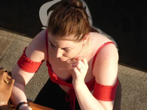 Redhead in little red top showing off her cleavage