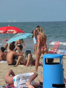 Sexy mom and daughter in red thongs at the beach