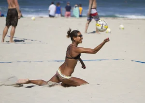 Hot girls playing beach volleyball in bikinis and shorts