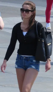 Cute girl with nice legs in short denim shorts