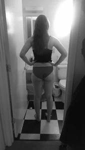 Black and White Home Creepshot of a Girl in Panties and a Top Standing in Bathroom