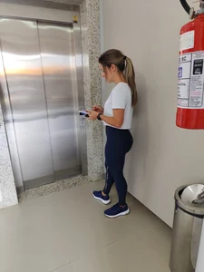Petite girl with perfect ass waiting for the elevator