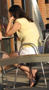 Lady in flop flops while eating showing her feet