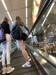 Hot Girls on the Mall Travelator in Mini Shorts and Her Friend in White Pants - Skinny Hot Legs Creepshots