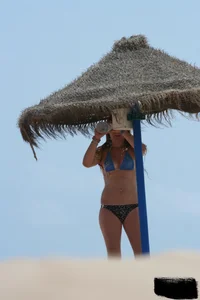 Hot beach girl undressing and going topless