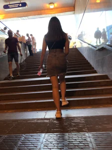 Hot chick wearing a fringed skirt walking up the stairs