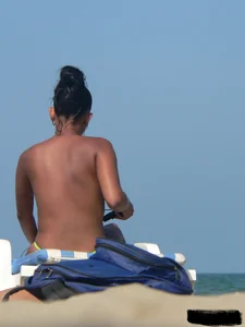Hot ass topless beach girl with great tits lets her little brother oil up her ass in thong bikini