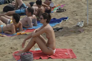 Topless girls on a beach in Barcelona