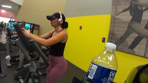 Smoking hot brunette working out at the gym in tight leggings