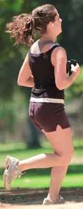 Cute girl running in short shorts