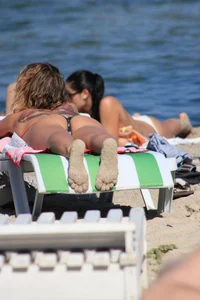 A couple sexy girls laying out on the beach