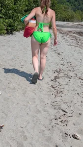 Beautiful Brown hair tight Girl in green bikini on the beach. oc