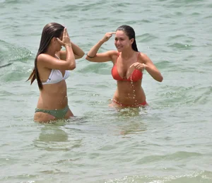 Two sexy ass girls on the beach in bikinis