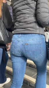 Nice big ass in tight blue jeans walking up stairs and standing in front of me