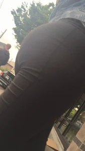 Girl with a nice ass in leggings walking down the street