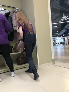 Cute candid shop assistant wearing boots and tight pants