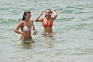 Two sexy ass girls on the beach in bikinis