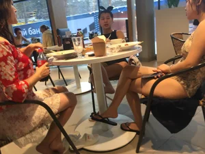 Asian Girls in Slippers in a Cafe Candid Photo