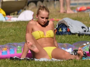 Blonde looking sexy in a yellow bikin