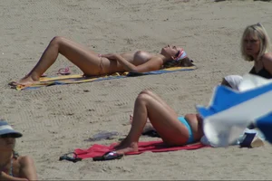 Girls on a nude beach in Sitges, Spain
