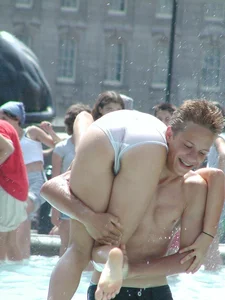Candid young candid girl in wet panties and T-shirt playing in fountain