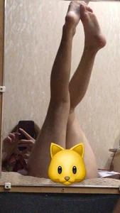 Skinny Barefoot Girl Sitting in Bed in a Skirt Mirror Selfie