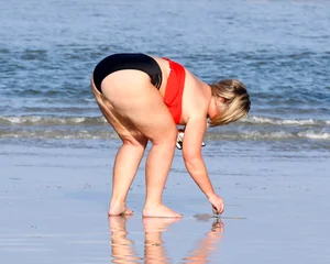 Thick BBW blonde lady in a bikini at the beach