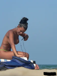 Hot ass topless beach girl with great tits lets her little brother oil up her ass in thong bikini