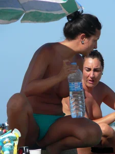 Bunch of sexy babes on the beach topless and in thong bikinis