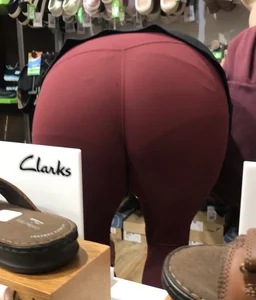 MILF in red leggings bends for the camera