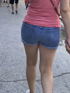 Bunch of girls in various outfits at a Cardinals baseball game