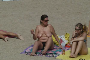 Topless girls on a beach in Barcelona