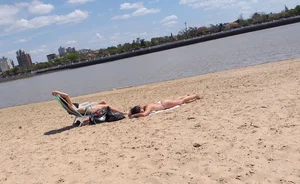 Girl laying out getting sun in a white thong bikini