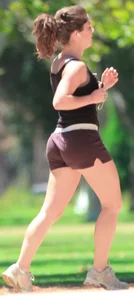 Cute girl running in short shorts