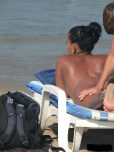 Hot ass topless beach girl with great tits lets her little brother oil up her ass in thong bikini
