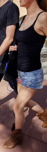 Cute girl with glasses in USA shorts showing her cheeks