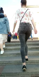 Hot booties of girls wearing tight pants, leggings and tight jeans walking up the stairs on the street creepshots
