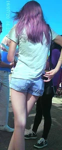 Skinny girl with purple hair in denim shorts
