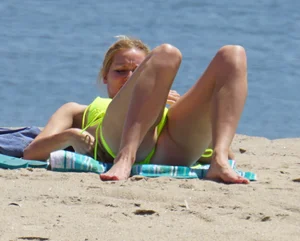 Sexy ass blonde milf on the beach in a thong with cameltoe and bending over