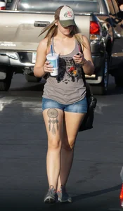 Hot blonde after shopping in short jean shorts and tank top