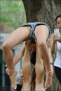 Gymnast or yoga girl in the park in shorts and no bra and even showing some pussy