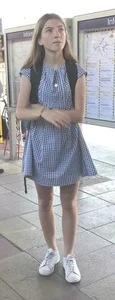 Cute girl wearing a dress at the train station