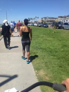 Hot brunette babe in leggings walking her dog with a nice ass and some cleavage