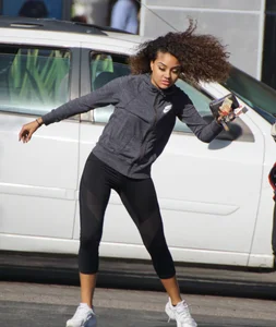 Beautiful black girl in Nike leggings in the parking lot