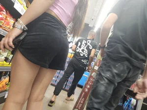 Nerdy girl in shorts looking for snaks