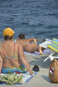 Sexy skinny babe in thong bikini on the beach