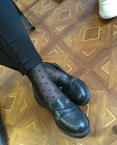 Closeups of college girls' legs and feet in pantyhose and various shoes (including high heels) in classrooms