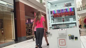Little blonde teen in grey leggings at the mall with her friends