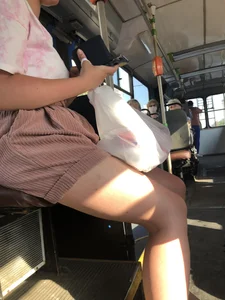 Young Girl in Sandals and Shorts in a Public Bus