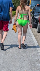 Beautiful Brown hair tight Girl in green bikini on the beach. oc